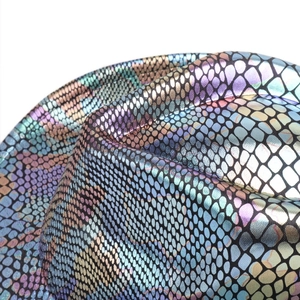 Macro shot of colorful iridescent snake scale texture on a western cowboy hat