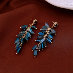 Detailed macro shot of vintage blue crystal tassel earrings with gold metal chain