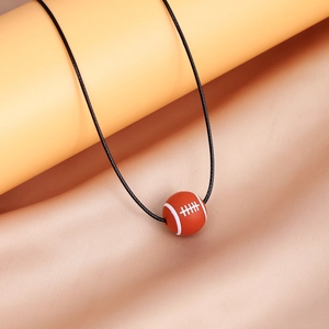 Detailed close-up of an American football pendant on a smooth silk background