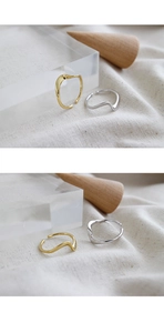 Close-up of minimalist wave textured S925 sterling silver rings in gold and silver