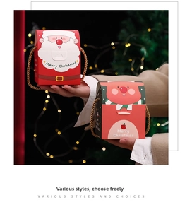Detail of Christmas gift boxes with Santa and reindeer prints and golden handles