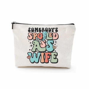 Canvas makeup bag with 'Somebody's Spoiled Ass Wife' print and black zipper closure