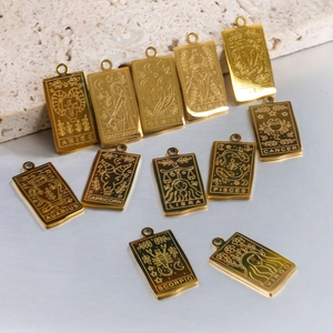 Golden rectangular tarot-style zodiac pendants in stainless steel with engraved names