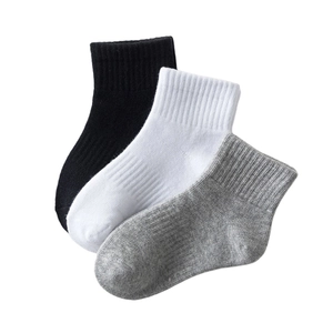 Three-pair set of kids ribbed cotton sports socks in black, white, and grey colors