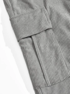 Macro shot of gray corduroy fabric texture and functional cargo pocket detail