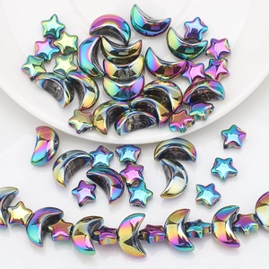 Close-up of iridescent moon and star glass beads for DIY jewelry making accessories
