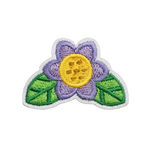 Flower embroidery patch with purple petals and green leaves on white background