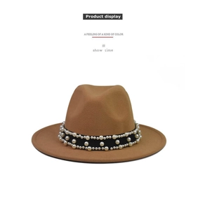 Detail of camel wool fedora hat featuring a wide black band with pearl embellishments