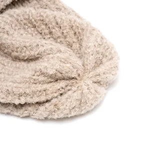 Chic beige textured knit beanie featuring high-quality reinforced stitching on the top