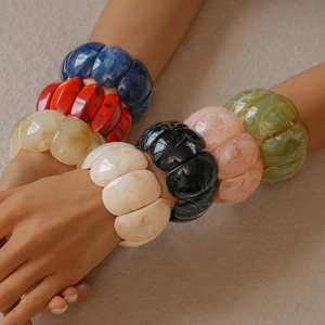 Detail of colorful resin acrylic bracelets with marble texture on a model's arm