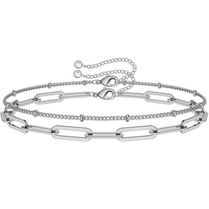Close-up of double-layer stainless steel link chain bracelet with seed beads and rhinestones