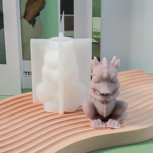 Detail view of a translucent silicone mold and a purple 3D dragon figurine sculpture