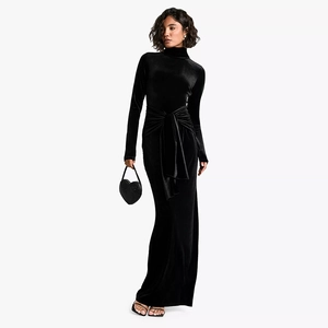 Detail of slim fit black velvet maxi dress with high neck and elegant waist tie design