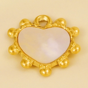 Macro detail of heart pendant with white mother of pearl inlay and beaded gold edge