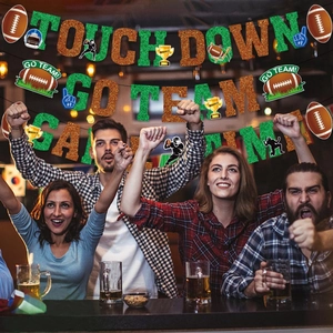 Glitter American football party banners with TOUCH DOWN and GO TEAM text in a bar setting