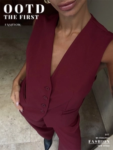 Detail view of burgundy V-neck vest with single-breasted buttons and matching trousers