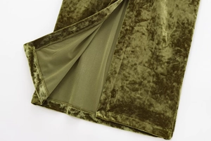 Detail view of the slit hem on a premium olive green velvet tube dress with silky texture