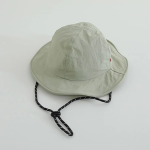 Detail of light green quick-dry sun hat showing breathable fabric and adjustable chin strap