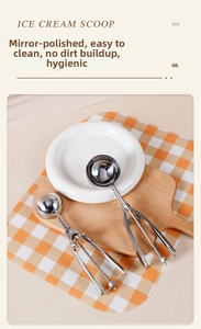 Macro view of polished stainless steel ice cream scoops with spring-loaded lever mechanism