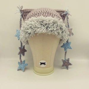 Detail view of handmade cat ear beanie with star charms and fluffy faux fur trim