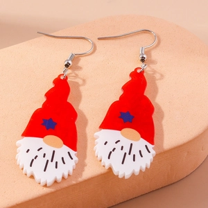 Detail of festive Christmas gnome earrings with red hats and white beards on hooks