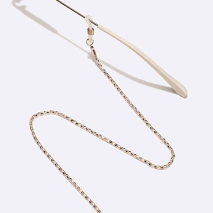 Detailed close-up of gold glasses chain with adjustable silicone anti-slip loops