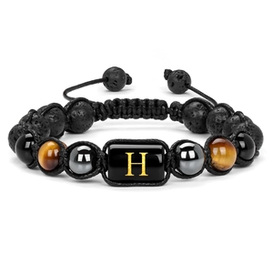 Macro shot of 10mm volcanic stone beads and golden letter H on a braided bracelet