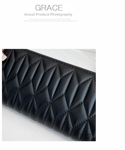 Detail view of premium black quilted PU leather wallet with textured diamond patterns