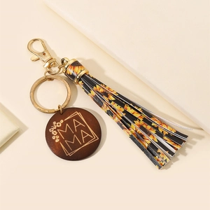 Detail of wooden MAMA pendant with sunflower tassel keychain and golden metal clip