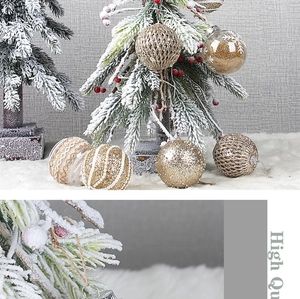 Detailed view of 8cm gold Christmas ornaments with glitter and woven texture details