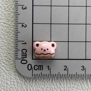 Close-up of pink bear resin charm on scale mat showing 1.5cm width measurement