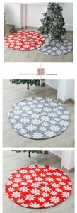 Detail of red and grey plush Christmas tree skirts with white snowflake patterns