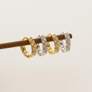 Detail of s925 silver and gold hoop earrings with double-row micro-pave zircons