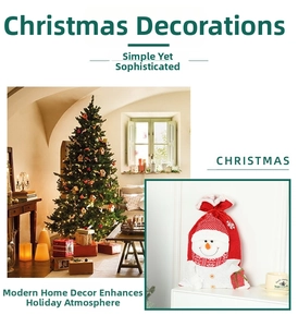 Detailed view of large knitted Christmas gift bag featuring 3D snowman with scarf