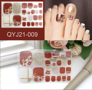 Burgundy and gold glitter toe nail stickers with flower patterns and gold line details