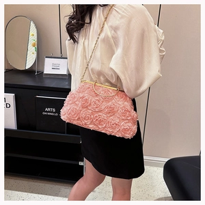 Detailed view of pink 3D fabric flower evening bag with a gold rhinestone clasp