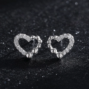 Elegant s925 silver irregular heart earrings with embedded gemstones on black background