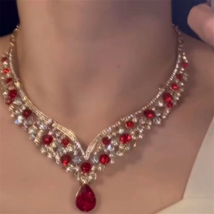 Luxurious gold jewelry set with red teardrop zircon necklace worn by a female model