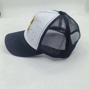 Detail of black and white mesh trucker hat with rhinestone accents and yellow label