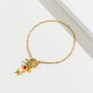 Gold vintage horn heart bracelet with colorful beads and OT toggle clasp on white background