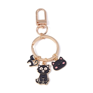 Golden metal keychain featuring black enamel cat charms and an owl pendant on white background