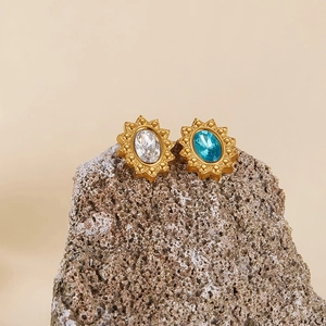 Vintage gold plated stainless steel sunburst earrings with oval blue and white gems