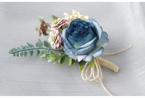 Detail of dusty blue artificial rose boutonniere with burlap rope and white berries