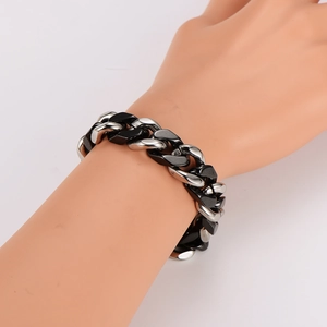 Hip hop style silver and black ceramic splice cuban chain bracelet on a male wrist