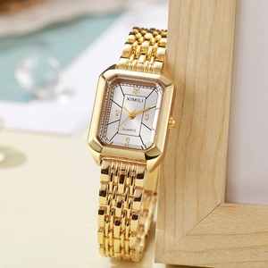 Macro detail of luxury square gold quartz watch with step-design case and fine metal link band
