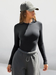 Detail of black ribbed long-sleeve top showing slim fit texture and round neckline style