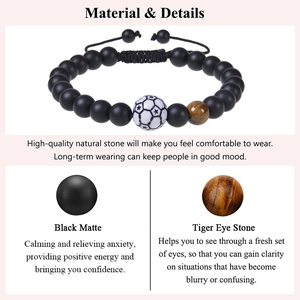 Detail of matte black stone and tiger eye bead bracelet with soccer charm on card