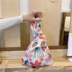 Japanese floral cotton linen wrist bag with orange plant patterns on off-white fabric