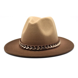 Detail of a two-tone wool fedora hat with khaki crown, dark brim and gold chain