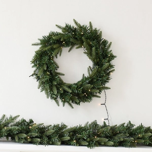Christmas wreath and garland with warm white LED lights for home festive decoration
